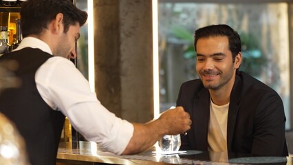Serving welcome refreshing drink of fizzy tonic or soda garnish with slice lime at beverage counter...