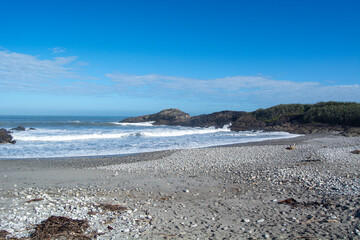 Serene Beach Scene with Gentle Waves and Clear Blue Sky