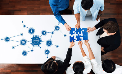 A dynamic scene showcasing a diverse team collaborating over a puzzle on a modern office table,...
