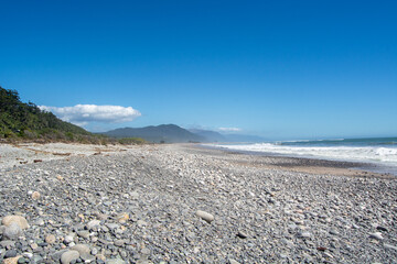 Serene Rocky Beach with Clear Blue Skies