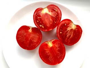 Imperfect yet fresh tomatoes on a plate. Celebrating the beauty of natural, ugly vegetables.