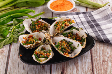 Gournet grilled oysters with onion and peanut