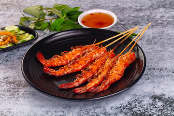 Grilled prawn skewer served sauce
