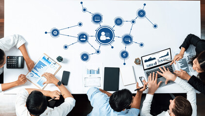 A diverse group collaborates in a modern office, utilizing technology and data analysis tools to drive insights, strategies, and effective brainstorming sessions. Amity