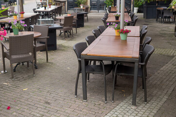 Empty outdoor restaurant tables and chairs waiting for customers