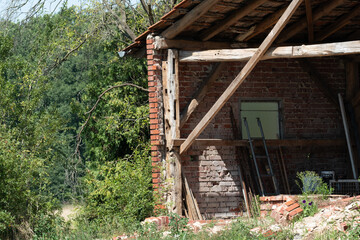 Old brick barn showing signs of decay in rural setting
