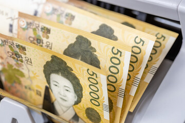 South Korean money, Korean won, banknotes in a counter, financial concept. Closeup