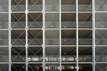 Modern parking garage facade featuring metal grid and concrete structure