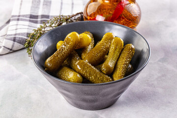 Marinated canned green cornichon cucumbers