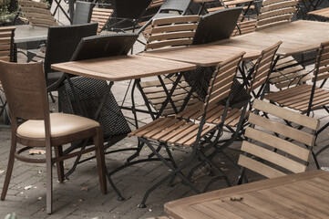 Empty outdoor cafe tables and chairs inviting customers