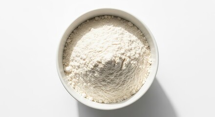 A white oval bowl filled with fine white powdered substance casting a shadow on a white surface