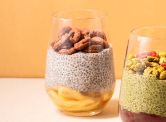 Honey Banana Almond Milk Chia Pudding cup topped with chocolate cereal closeup side view of healthy breakfast