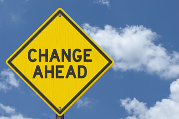 Change Ahead yellow warning sign with sky
