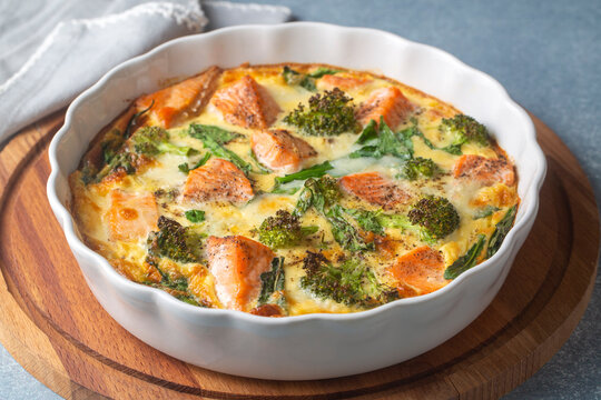 Egg-based frittata, omelette with salmon, broccoli and spinach. Italian dish, crustless quiche with eggs, fish and vegetables. Mediterranean ketogenic healthy diet
