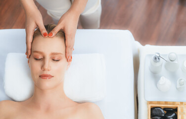 Panorama top view of woman enjoying relaxing anti-stress head massage and pampering facial beauty...