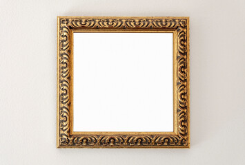 Ornate golden empty picture frame on the wall