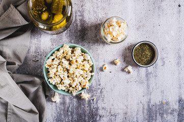 Pickles dill aromatic popcorn in a bowl on the table top view