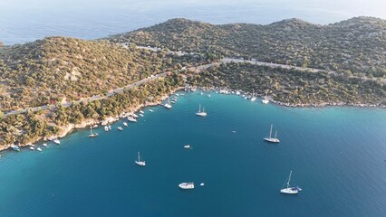 Boats coastal town. Coastal mountain landscape, sea resort yachts, golden hour