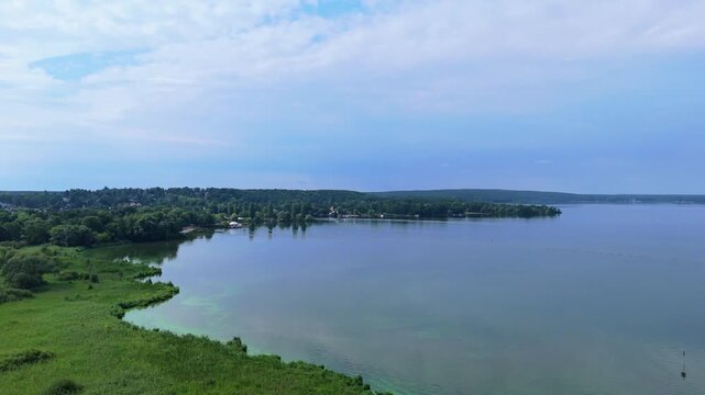 Schwielowsee lake near Potsdam, Germany,. Scenic progression over tranquil waters, showcasing lush greenery and serene reflections, capturing the essence of nature's beauty in a continuous motion sequ