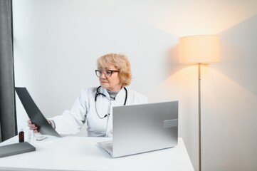 Photo of aged woman qualified doctor look lungs x-ray wear white coat workplace office indoors