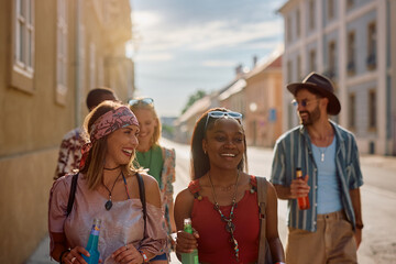 Multiracial group of happy friends going to summer music festival.
