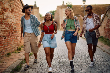 Young happy people going to summer music festival.