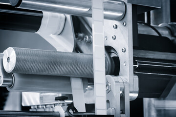 Fragment of the conveyor of sticking labeling machine. industrial concept