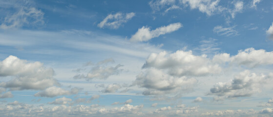 Fototapeta premium heaven sky is blue with many clouds. clouds are scattered throughout the sky and are of various sizes.