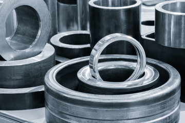 Collection of metal cylinders with one of them being silver. The silver cylinder is in the middle...