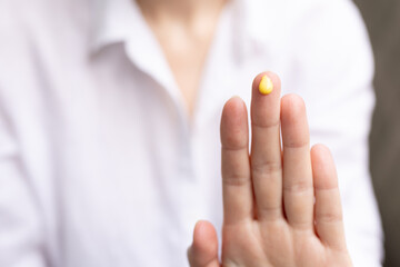 Closeup of a woman using a retinal serum.