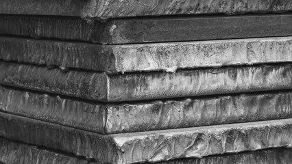 Stack of metal sheets with rust.  plates are stacked on top of each other and have traces of laser...