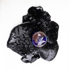 business concept,Black barrel with spilled oil isolated on white background