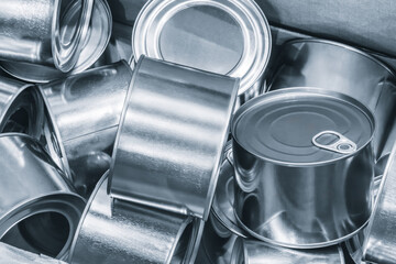 Box full of metal cans as background food production concept.