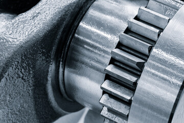 Engine crankshaft close up, car engine service concept background blue tone.