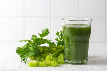 A glass of green celery juice - smoothie. Celery drink prepared for healthy nutrition and detox.