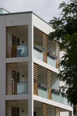 Balconies of a modern apartment building with glass and wood details