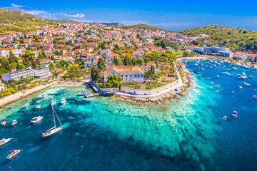 Drone image of Hvar town showing the scenic waterfront promenade, picturesque harbor with anchored...