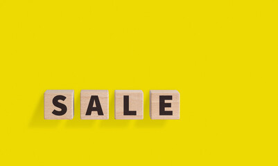 Wooden Blocks with SALE Text on Yellow Background for Promotional Designs