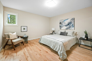 Fototapeta premium Bedroom with a white bed and a chair
