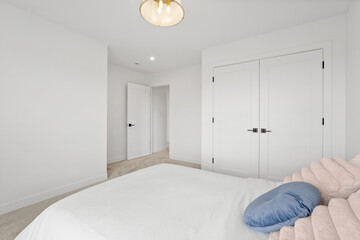 Bedroom with a white door and a white closet