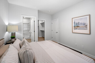 Bedroom with a white bed and striped pillows