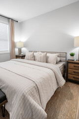 Bedroom with a white bed and a striped comforter