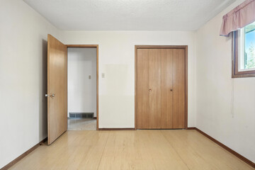 Bedroom with a wooden door and a window