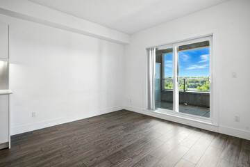 Large open living room with a large window overlooking a city