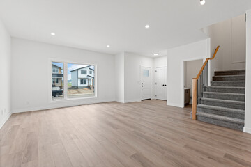 Large open living room with a staircase leading to the second floor