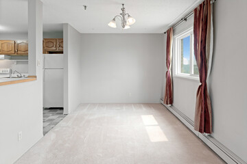 Large, empty living room with a window and a fireplace