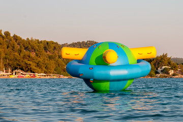 Water inflatable attraction on the seaside. Toy on the sea. 