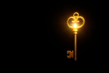 An antique gold key with a backlight on a black background. Space for text.