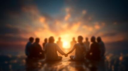 Individuals sitting in a circle holding hands at sunset. Soft hues of orange and yellow illuminate the scene on calm waters. Concept of wellness, meditation, spiritual gatherings