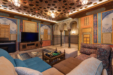 Moroccan-inspired design with vibrant colors, intricate designs on the walls, and comfortable...